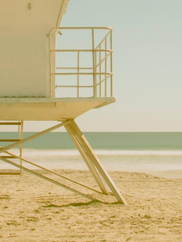 Bitcoin Swimwear Mobile Image with Beige lifeguard tower on a sandy beach with ocean in the background
