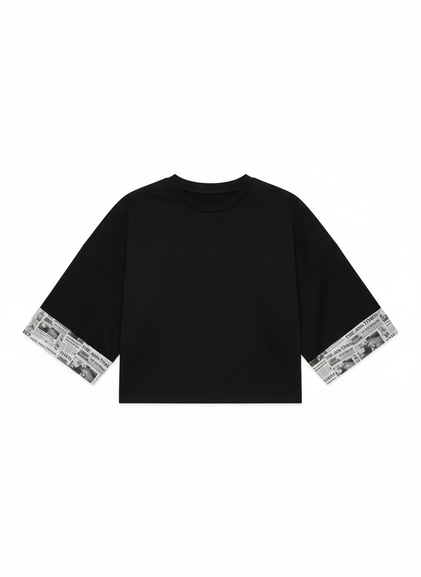 Black Chancellor Bitcoin crop top with newspaper trim on sleeves and hem against a white background