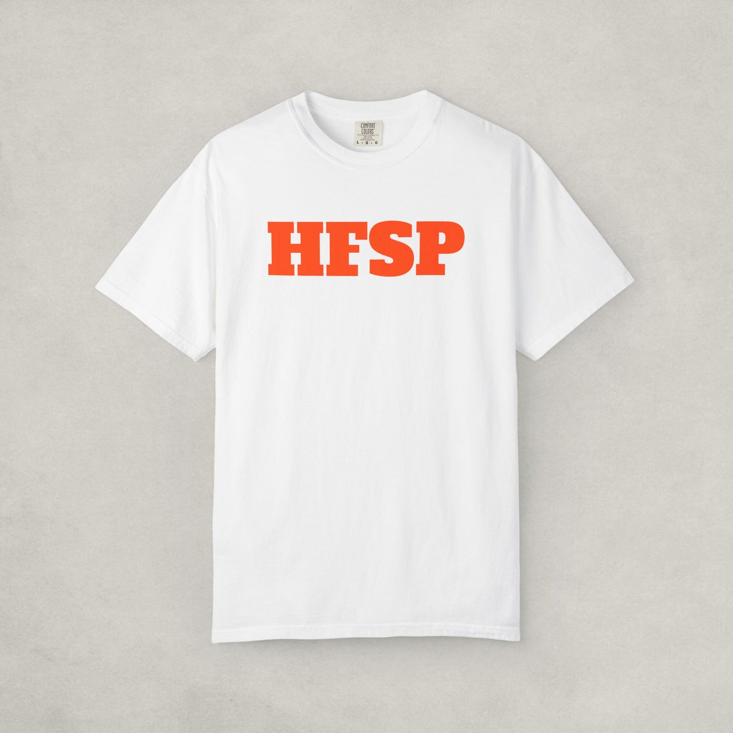 White t-shirt by SVRNT with 'HFSP' printed in orange on a light gray background | The Orange Habit