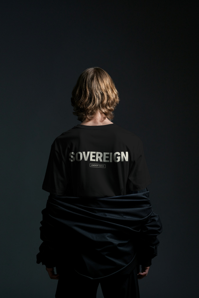 Person wearing a black 'SOVEREIGN' t-shirt against a dark background