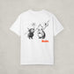 Back of the white t-shirt by SVRNT with 'REKT' printed in orange on a light gray background | The Orange Habit