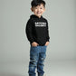 Child wearing a black hoodie with 'Satoshi Nakamoto' text on a gray background