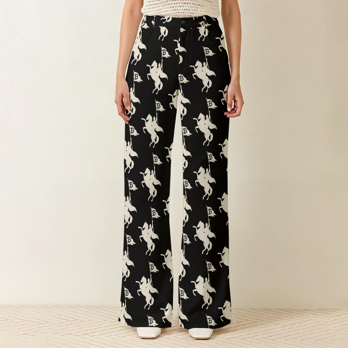 Black Bitcoin themed pants with white pattern worn by a woman on a neutral background SVRN Society