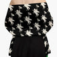 Black off-shoulder top with white graphic design on a plain background