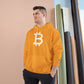 Man wearing a (Gold) hoodie with a Bitcoin logo against a neutral background