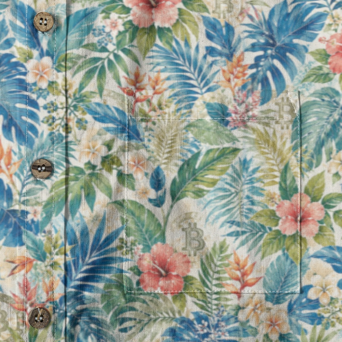 Close-up of a tropical floral patterned shirt with buttons.