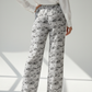 Person wearing wide-leg bitcoin pants with a newspaper print in a living room setting.