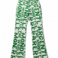 White bitcoin pants with green fix the money fix the world text pattern on a white background