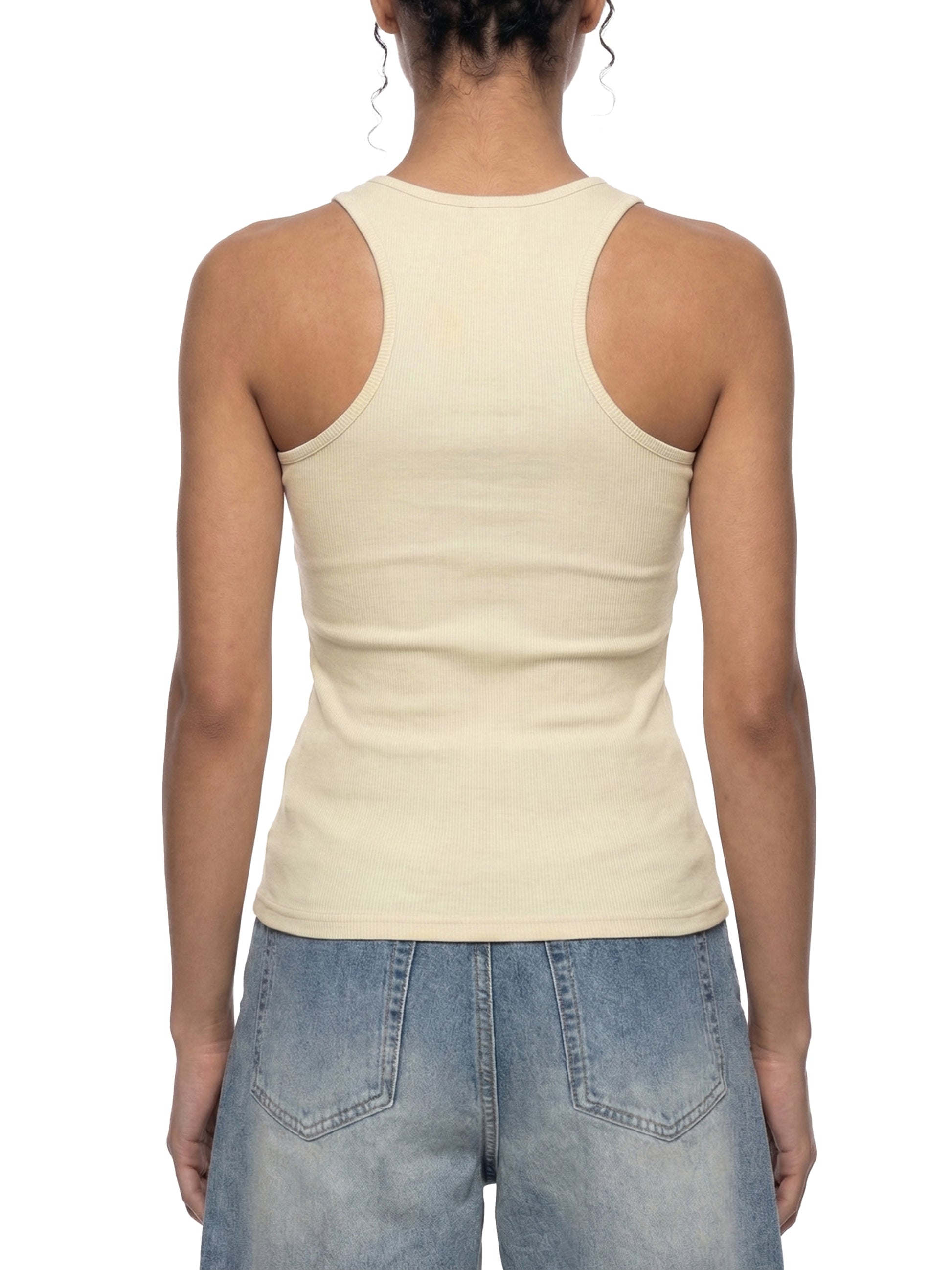 Person wearing a beige tank top and blue jeans on a white background