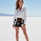 Woman wearing a white shirt and black bitcoin logo shorts at the salt flats