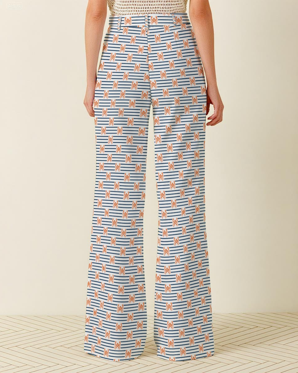 Person wearing blue and white striped pants with a pattern of small shapes on a beige background