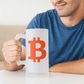Person sitting next to Bitcoin mug