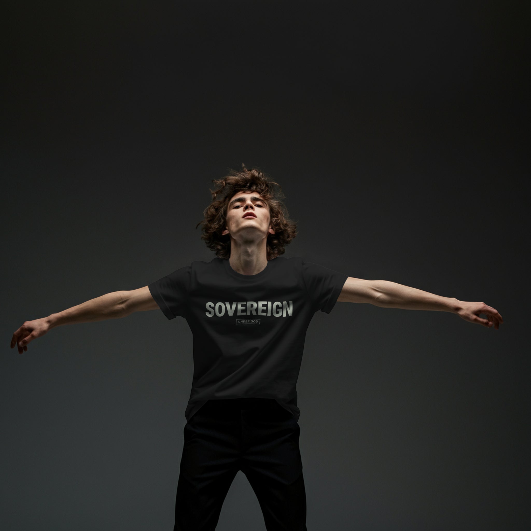 Person wearing a black t-shirt with 'SOVEREIGN' text against a dark background