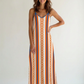 Woman wearing a striped Bitcoin dress with orange and blue pattern on a white background
