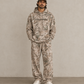 Man wearing a matching Kayfabe tree camo hoodie and fleece sweatpants set