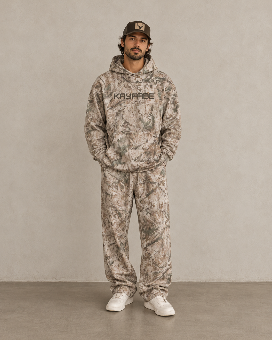 Man wearing a matching Kayfabe tree camo hoodie and fleece sweatpants set